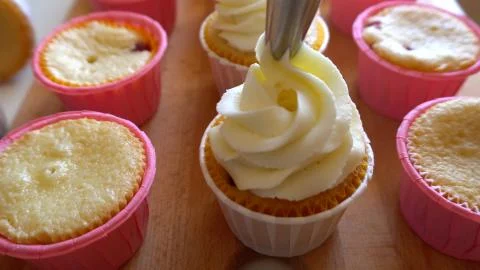 Decorating Muffins with Cream Stock Photos