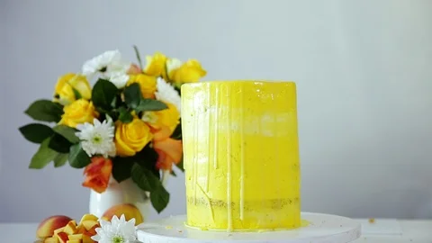 Decorating multi-layered wedding cake with glazing using spoon. Stock Footage 102043053