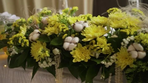 Decorating the newlyweds' wedding table with yellow flowers Stock Footage 314341932