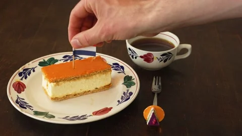 Decorating orange tompouce with dutch flag Stock Footage 239931594