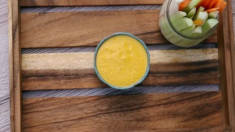 Decorating Orange Vegetable Sauce with Greenery in Bowl. Top View. Vegan and Video stock 107148913