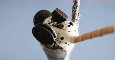 Decorating parfait with Oreo cookies and ice cream and biscuits Stock Footage 134683065