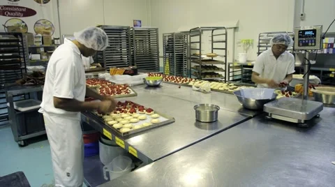 Decorating pastries at a commercial bakery Stock Footage 1087100