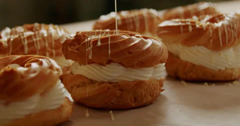 Decorating pastries with icing at a bakery close-up in 4K. Stock Footage 221565040