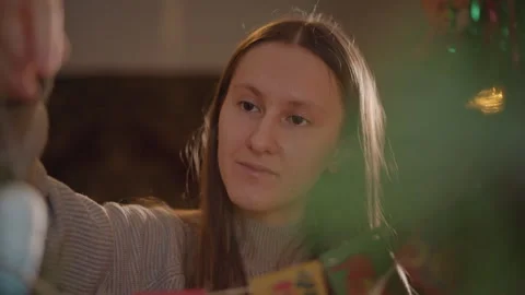 Decorating pine branch with handcrafted festive ornament. Smiling woman Stock Footage 347337612
