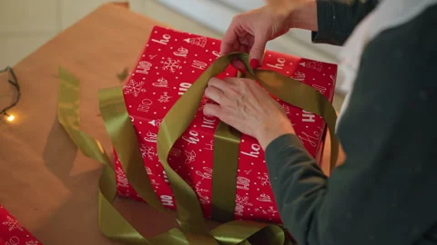 Decorating present with holiday ribbons. Wrapping and styling Christmas gift Stock Footage 338286496