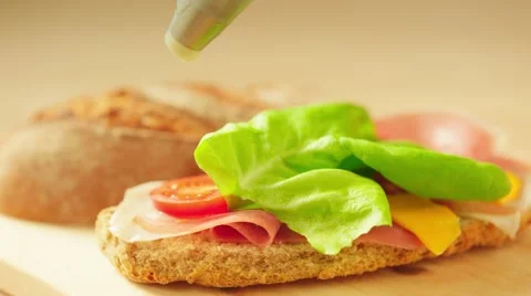 Decorating sandwitch with mayonnaise Stock Footage 64214707