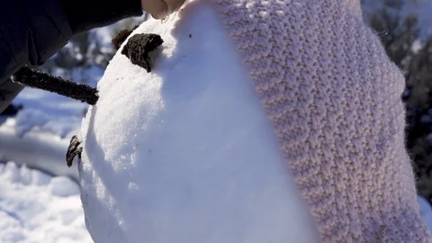 Decorating snowman by adding hair Stock Footage 100888497