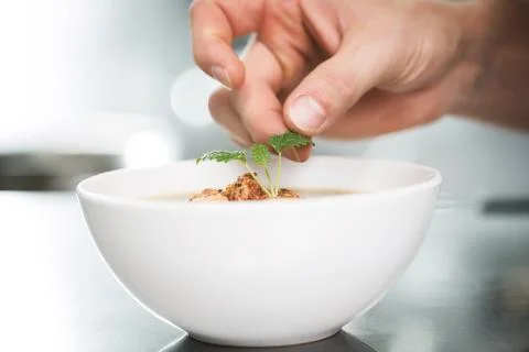 Decorating soup with melissa Stock Photos
