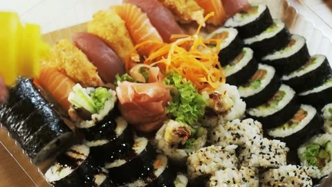 Decorating Sushi With Sesame Seeds Stock Footage 71072008