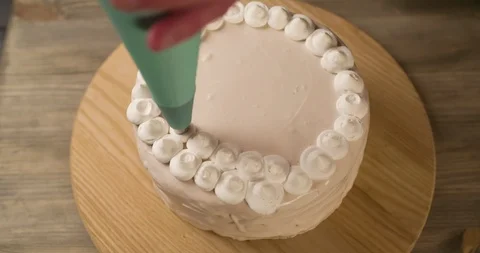Decorating sweet Cake with white Cream decor Top view 4K Stock Footage 103256162