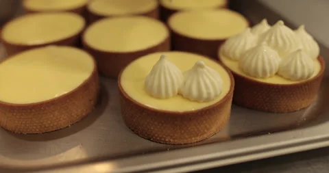 Decorating tartlets with cream using a culinary syringe. Stock Footage 255933756