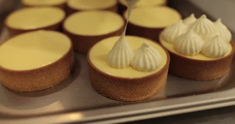 Decorating tartlets with cream using a culinary syringe. Stock Footage 255933891