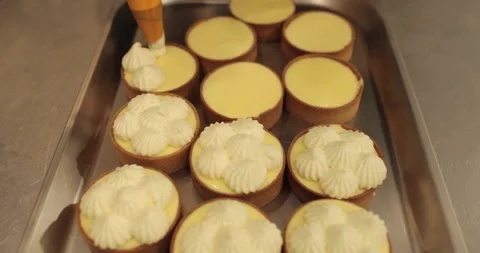 Decorating tartlets with cream using a culinary syringe. Stock Footage 255934053