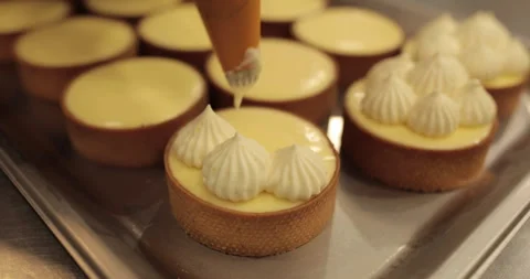 Decorating tartlets with cream using a culinary syringe. Stock Footage 255934145