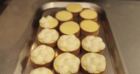 Decorating tartlets with cream using a culinary syringe. Stock Footage 255934266