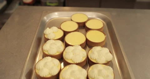 Decorating tartlets with cream using a culinary syringe. Stock Footage 255934304