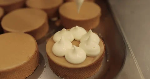 Decorating tartlets with cream using a culinary syringe. Stock Footage 255934614