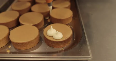 Decorating tartlets with cream using a culinary syringe. Stock Footage 255934682