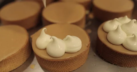 Decorating tartlets with cream using a culinary syringe. Stock Footage 255934971