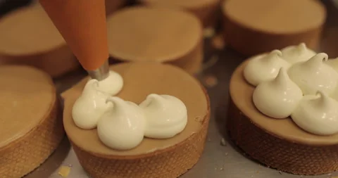Decorating tartlets with cream using a culinary syringe. Stock Footage 255934973