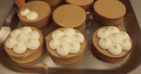 Decorating tartlets with cream using a culinary syringe. Stock Footage 255936247