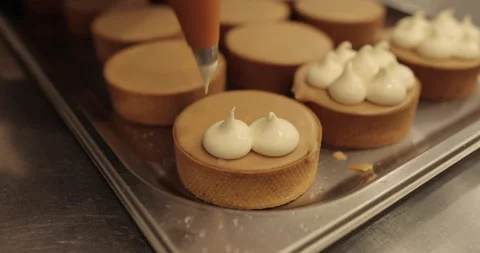 Decorating tartlets with cream using a culinary syringe. Stock Footage 255936655