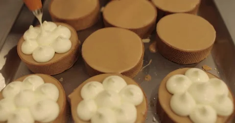 Decorating tartlets with cream using a culinary syringe. Stock Footage 255937243