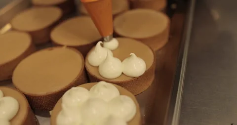 Decorating tartlets with cream using a culinary syringe. Stock Footage 255938104