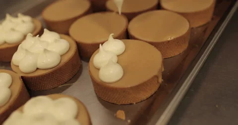 Decorating tartlets with cream using a culinary syringe. Stock Footage 255938466