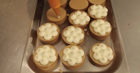 Decorating tartlets with cream using a culinary syringe. Stock Footage 255938821
