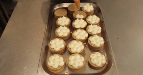 Decorating tartlets with cream using a culinary syringe. Stock Footage 255939057