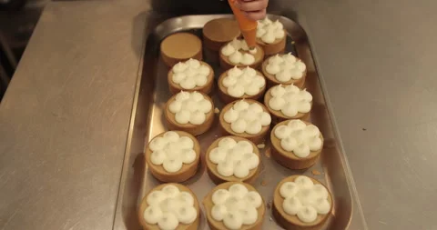 Decorating tartlets with cream using a culinary syringe. Stock Footage 255939579