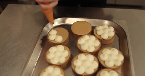 Decorating tartlets with cream using a culinary syringe. Stock Footage 255940327
