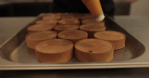 Decorating tartlets with cream using a culinary syringe. Stock Footage 255940494