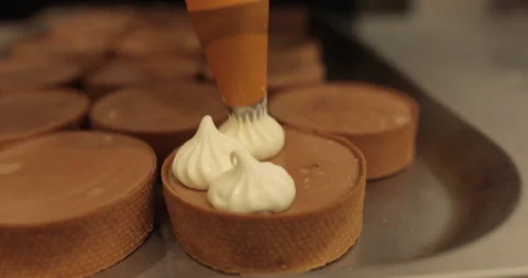 Decorating tartlets with cream using a culinary syringe. Stock Footage 255941186