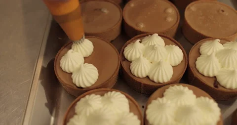 Decorating tartlets with cream using a culinary syringe. Stock Footage 255945286