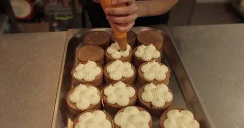 Decorating tartlets with cream using a culinary syringe. Stock Footage 255945561