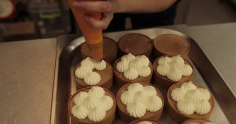 Decorating tartlets with cream using a culinary syringe. Stock Footage 255946627