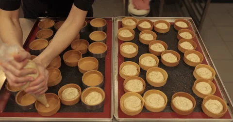 Decorating tartlets with cream using a culinary syringe. Stock Footage 255947097
