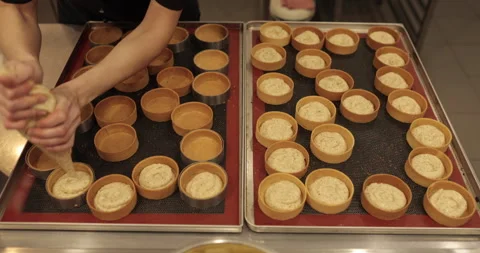 Decorating tartlets with cream using a culinary syringe. Stock Footage 255947361