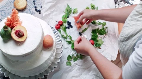 Decorating tier cake with fresh green, peach and cherry Stock Footage 68019902