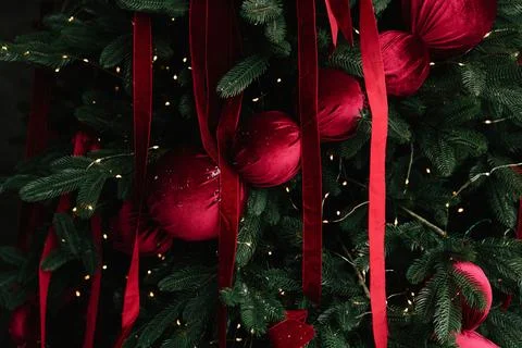 Decorating tree with bright Christmas baubles and ornaments. Stock Photos