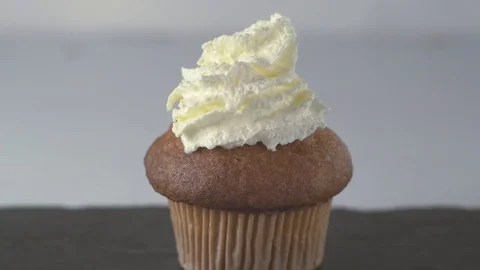 Decorating vanilla cupcake with cocktail cherry. Close up. Stock Footage 70657650