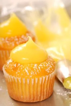 Decorating vanilla cupcakes Stock Photos