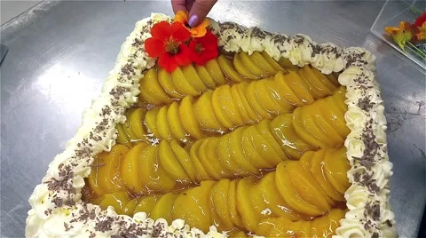 Decorating a yellow peach cake with whipped cream Stock Footage 55571782