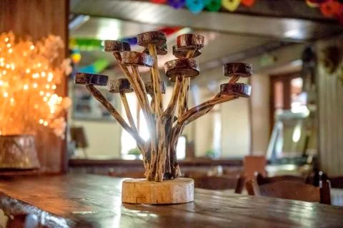 Decoration art objects. Hand made wooden candle holder on table. Stock Photos
