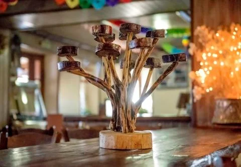 Decoration art objects. Hand made wooden candle holder on table. Stock Photos