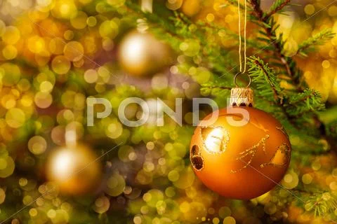 Decoration bauble on decorated Christmas tree background Stock Photos