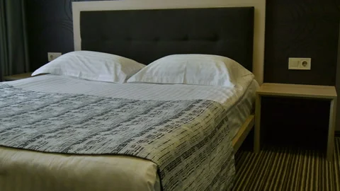 Decoration in bedroom interior. Double bed in the hotel room without people Video stock 106991897